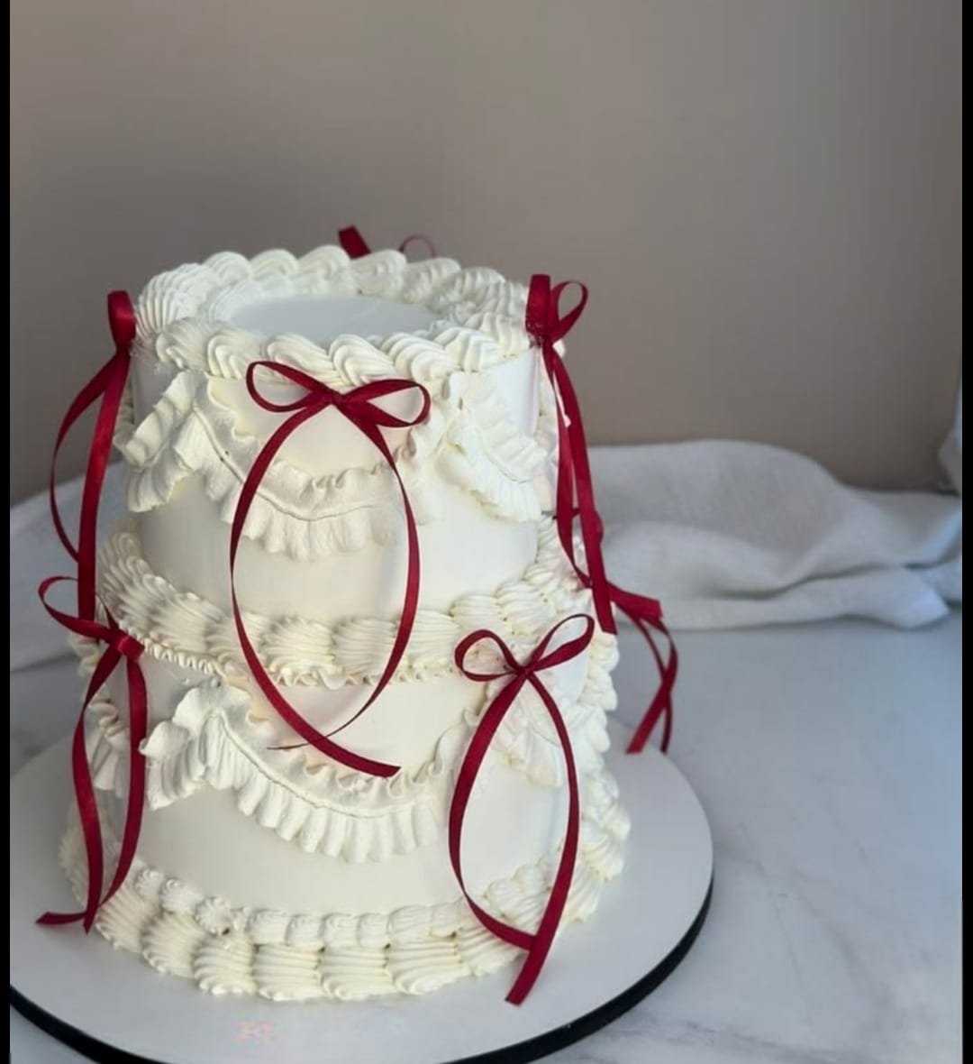 Classy white with red ribbons mini tier cake